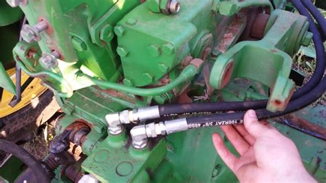 A magnifying glass. . How to check hydraulic fluid on john deere 5055e